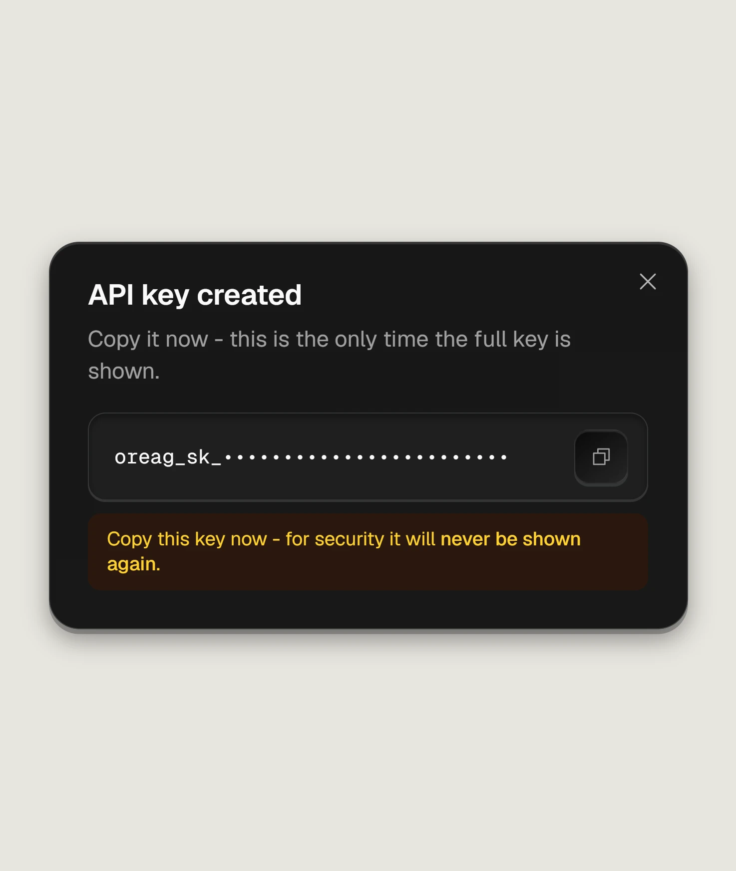 Oreag - the API key created dialog: the new key, masked here, shown once with a copy button and the warning that it will never be shown again.